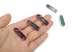 Fluorite bullet-shaped gemstone carving by GemstoneGO, showcasing vibrant purple-green colors and smooth polished surface.