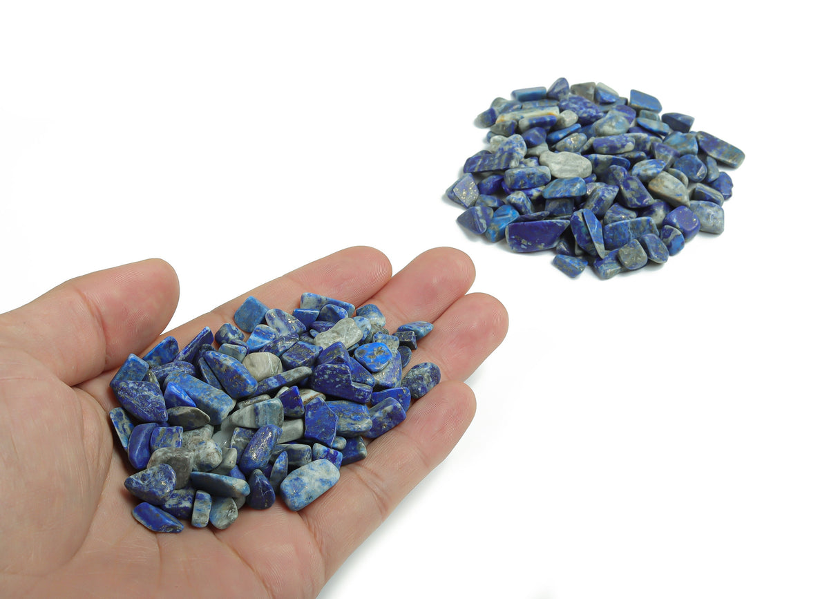 Semi-tumbled Lapis Lazuli crystal chips, 7-12mm, in bulk from GemstoneGO, showcasing deep blue stones with gold-colored pyrite inclusions.