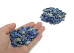 Semi-tumbled Lapis Lazuli crystal chips, 7-12mm, in bulk from GemstoneGO, showcasing deep blue stones with gold-colored pyrite inclusions.