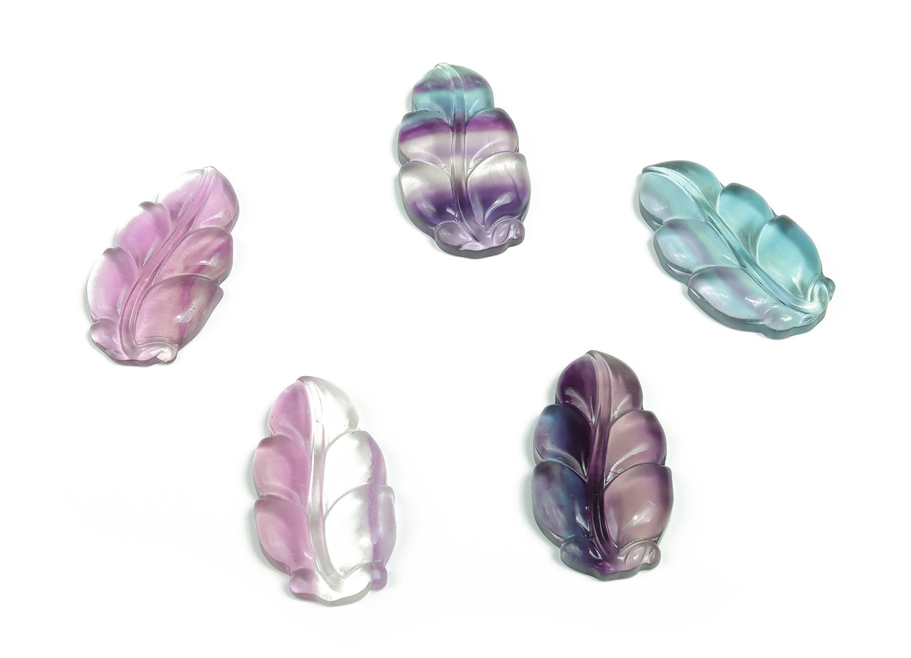 Fluorite leaf carving gemstone by GemstoneGO, detailed green and purple fluorite with intricate leaf design.