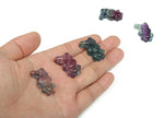 Fluorite rabbit gemstone carving from GemstoneGO featuring a colorful, polished rabbit figure on a smooth surface.