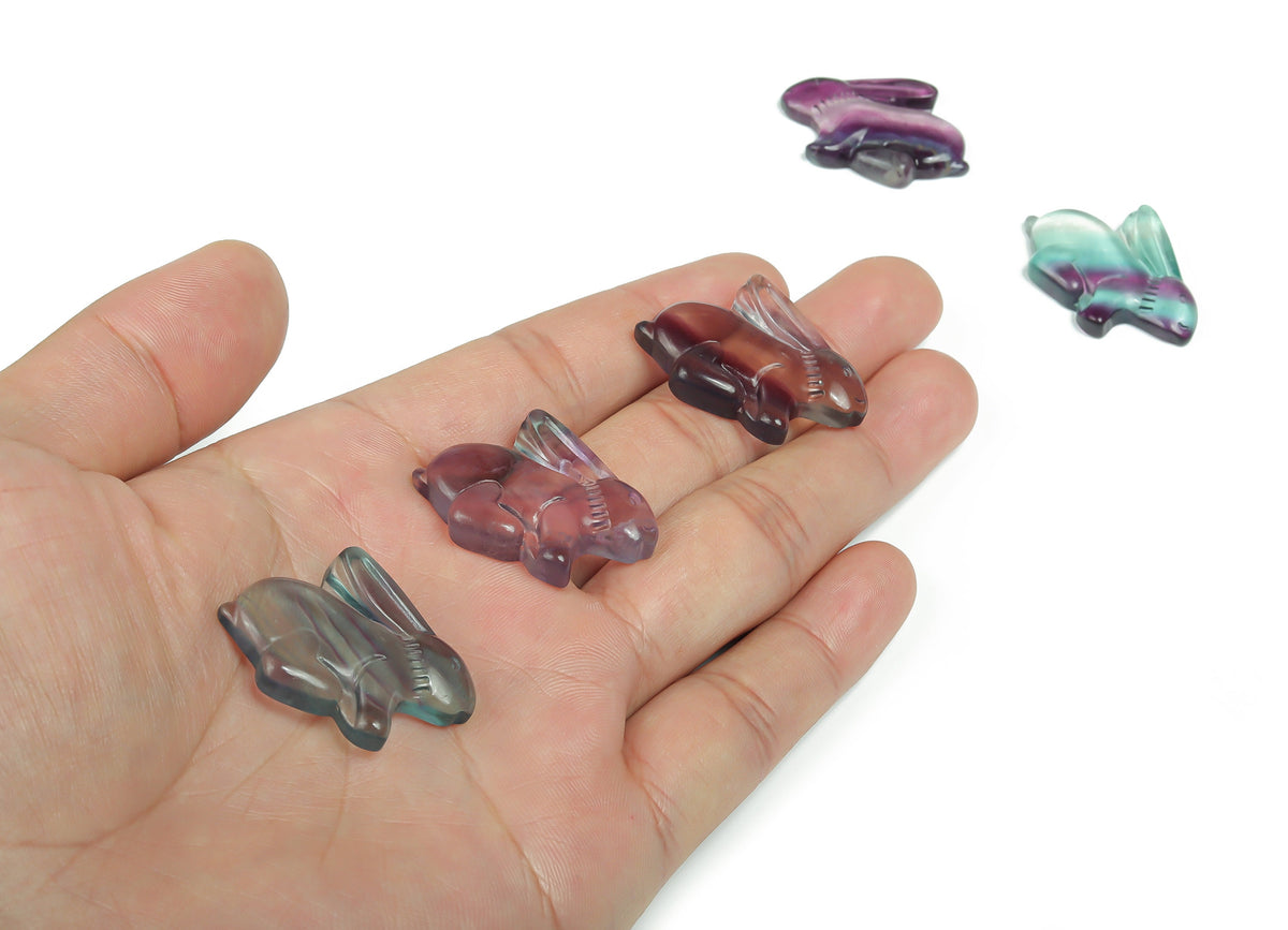 Colorful fluorite rabbit gemstone carving with vibrant purple, green, and blue hues by GemstoneGO.