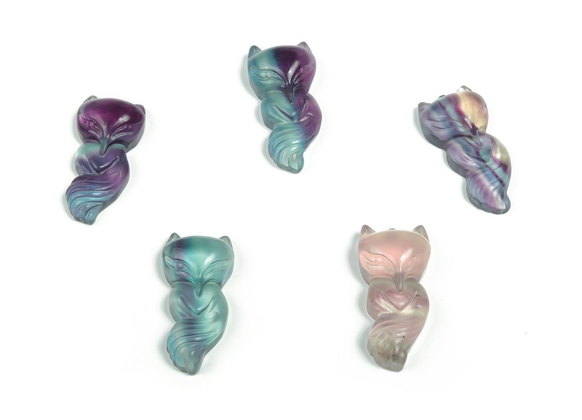 Fluorite nine-tailed fox gemstone carving by GemstoneGO, detailed multicolored carved figurine on a plain background