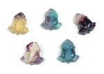 Fluorite rose flower carving gemstone by GemstoneGO, showcasing intricate pink and purple carved floral design on smooth stone