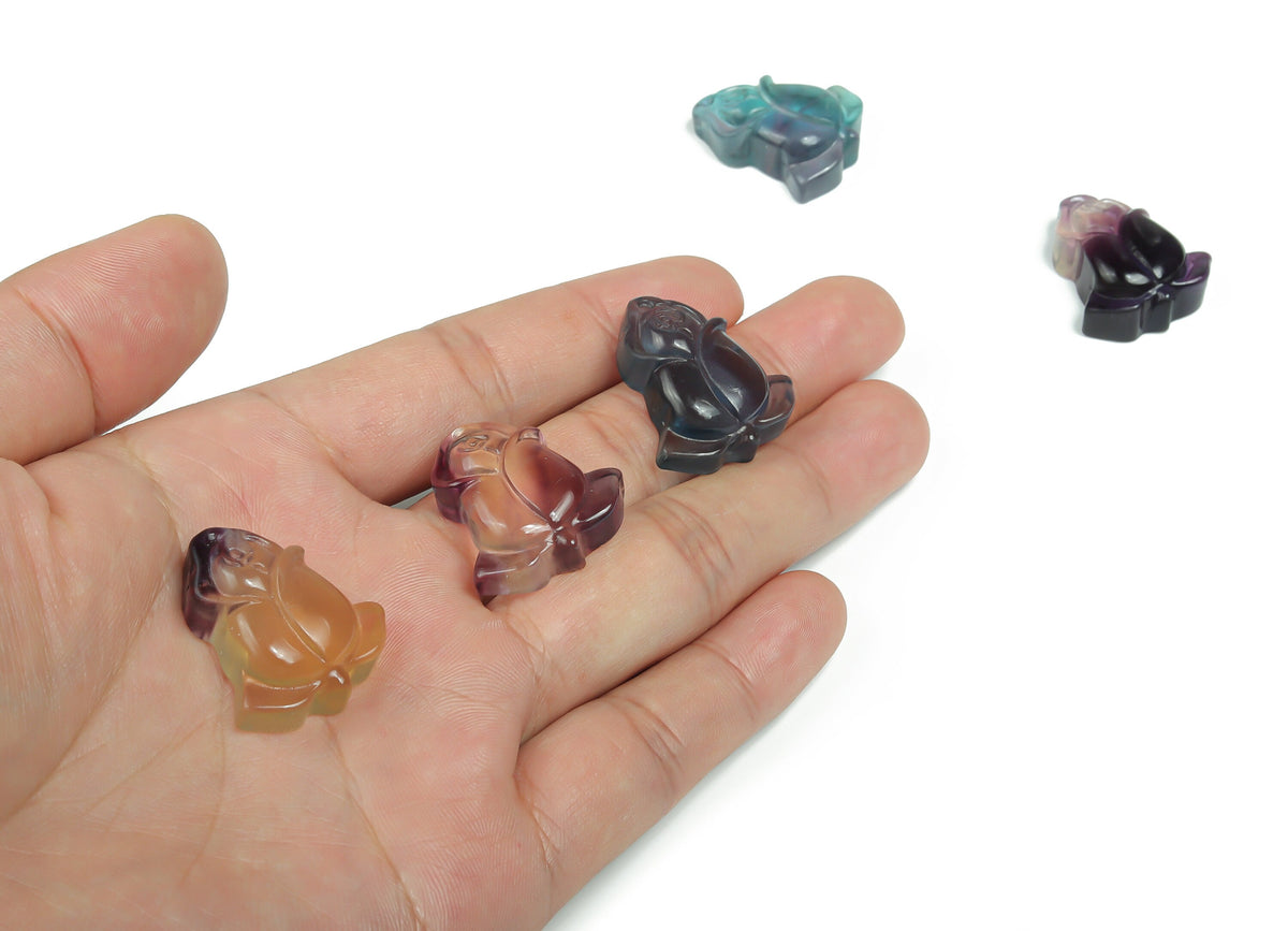 Fluorite rose flower gemstone carving by GemstoneGO, showcasing vibrant purple and green hues with intricate floral details.