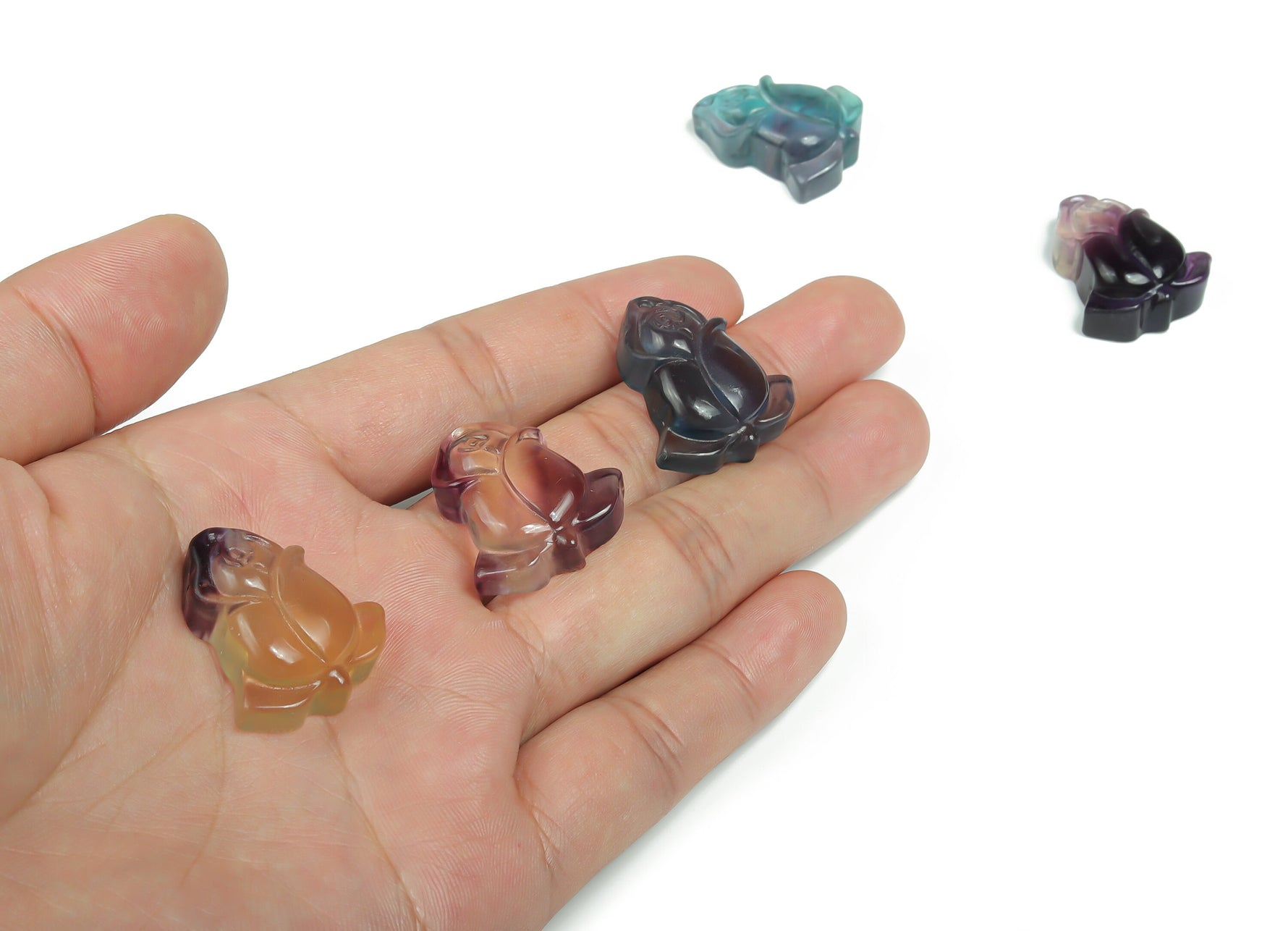 Fluorite rose flower gemstone carving by GemstoneGO, showcasing vibrant purple and green hues with intricate floral details.