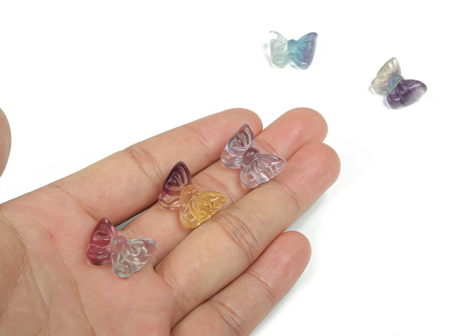 Fluorite butterfly carving gemstone from GemstoneGO showing vibrant green and purple hues with detailed wing patterns.