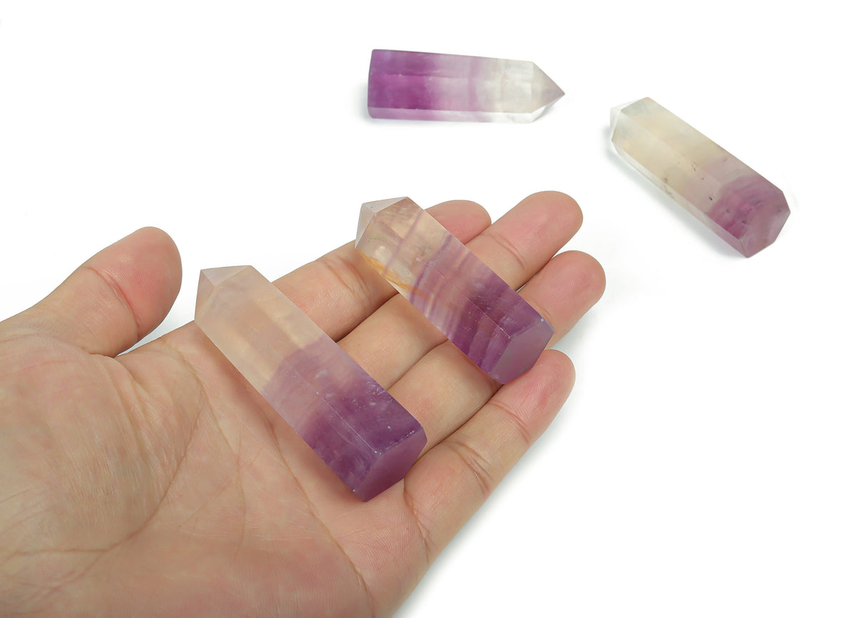 Watermelon Fluorite obelisk tower crystal from GemstoneGO, featuring vibrant green and pink hues with smooth polished surfaces.