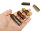 Tiger Eye obelisk tower crystal from GemstoneGO, featuring a polished golden-brown stone with natural banding and a pointed top.