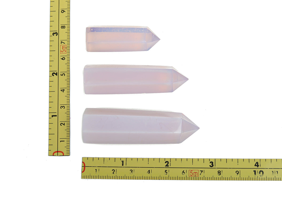Pink Opalite Obelisk Tower crystal from GemstoneGO, showcasing a smooth, polished pink gemstone obelisk with subtle iridescence.