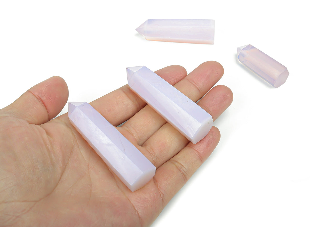 Pink Opalite obelisk tower crystal from GemstoneGO, showcasing a smooth, polished pink gemstone with a pointed obelisk shape.