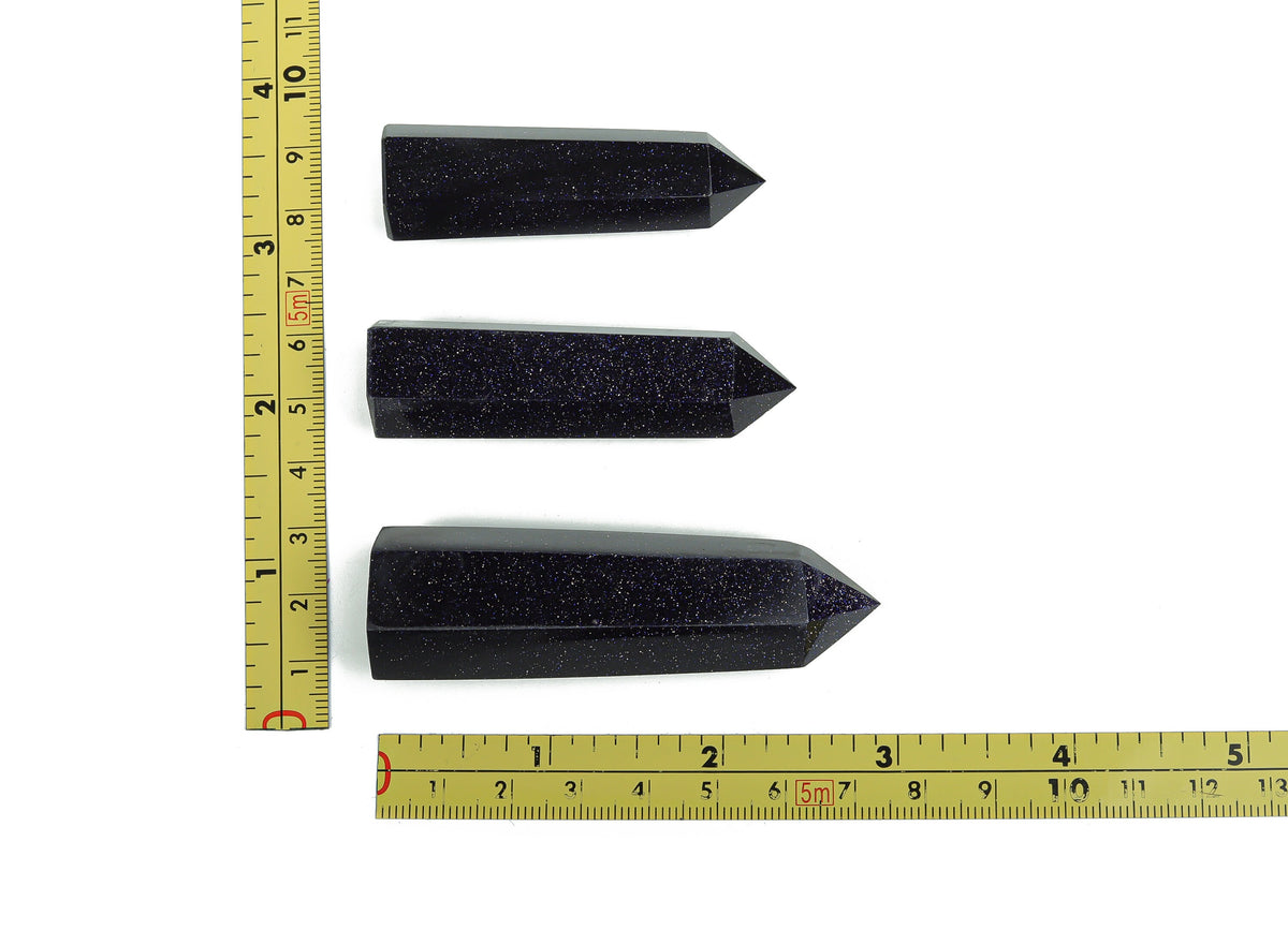 Blue Goldstone obelisk tower crystal by GemstoneGO, showcasing a polished blue and gold-colored gemstone obelisk with smooth surfaces.