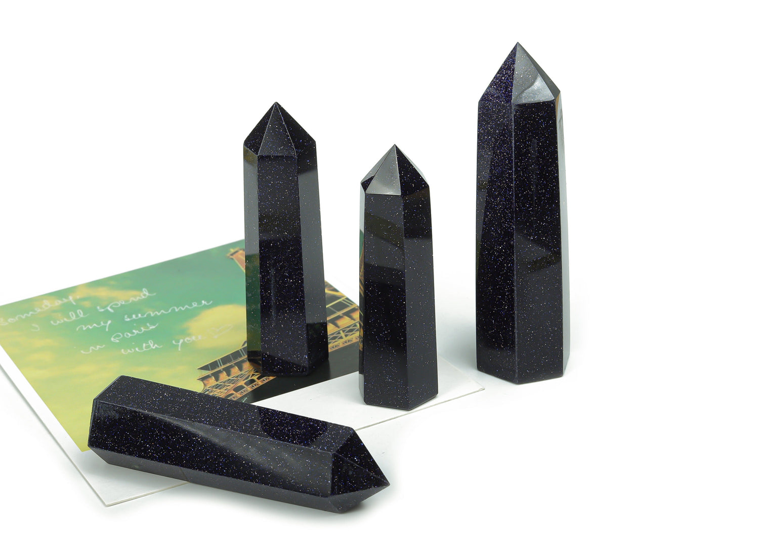 Blue Goldstone obelisk tower crystal from GemstoneGO with a deep blue and gold flecked surface, polished and tapered shape.