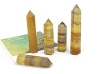 Yellow fluorite obelisk tower crystal from GemstoneGO showing a vibrant yellow crystal with natural striations and smooth polished surfaces.