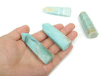 Amazonite obelisk tower crystal by GemstoneGO, showing a polished blue-green gemstone with natural striations and pointed shape.