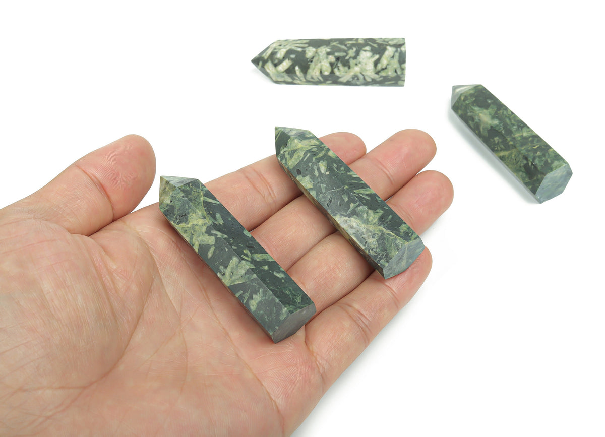 Chinese writing obelisk tower made of chrysanthemum stone crystal, showcasing natural patterns and a polished finish.