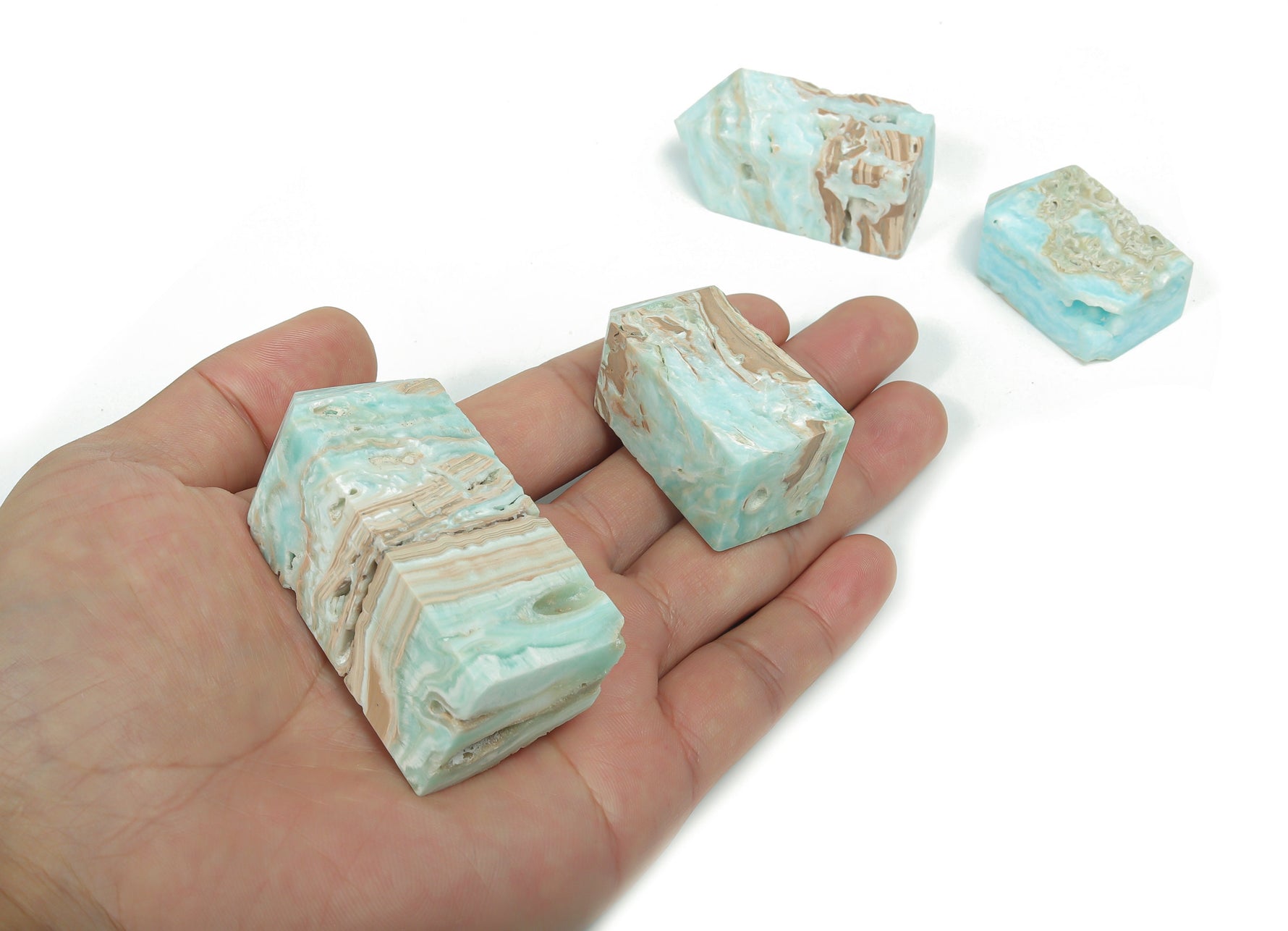 Blue Caribbean Calcite Druzy Obelisk Tower crystal from GemstoneGO, showcasing a vibrant blue mineral with sparkling druzy details.