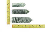 Green Zebra Calcite obelisk tower crystal from GemstoneGO, featuring vibrant green and yellow striped patterns and a pointed tip.