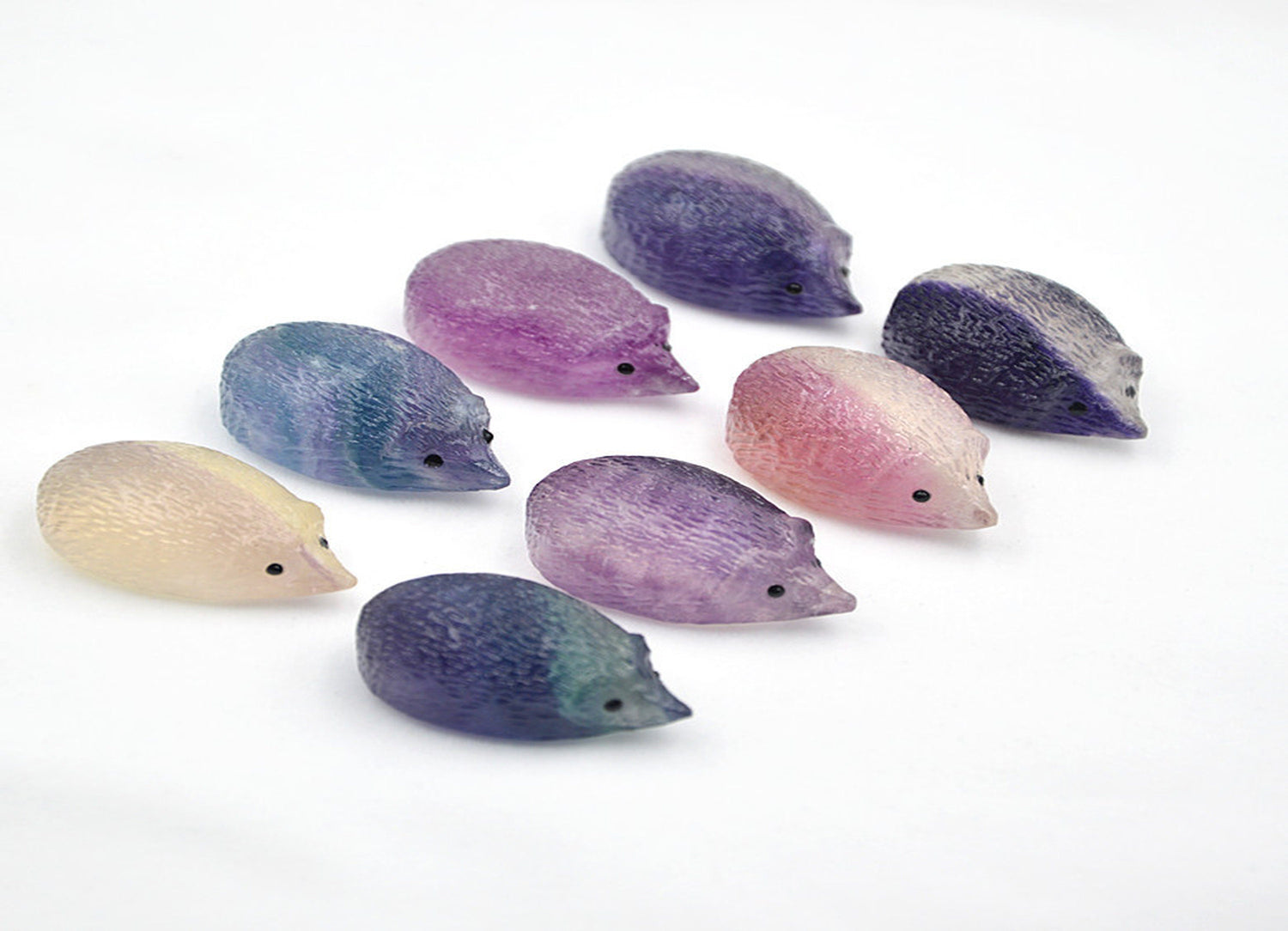 Colorful fluorite hedgehog gemstone carving from GemstoneGO, showcasing vibrant layers and detailed animal sculpture.