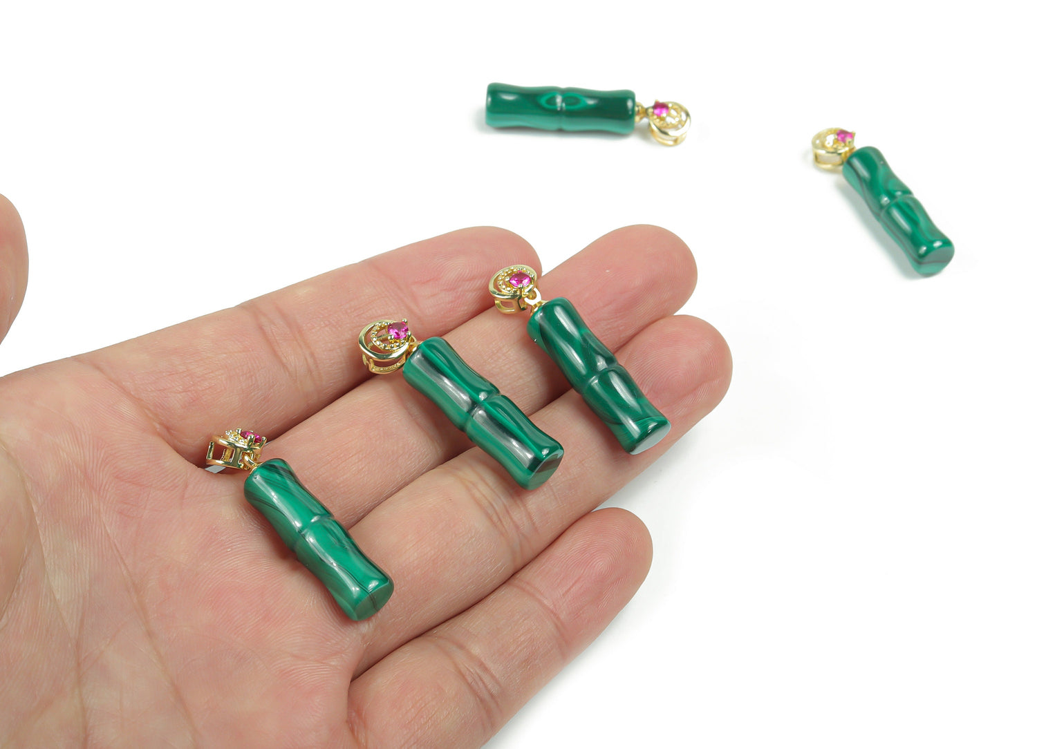 Malachite crystal pendant from GemstoneGO featuring a polished green gemstone with natural banding and a silver bail attachment.