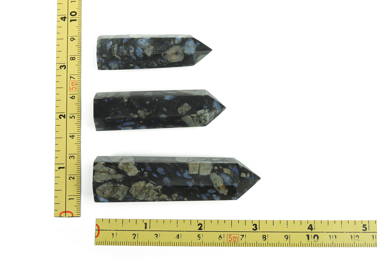 Blue Liberite Que Sera Obelisk Tower crystal from GemstoneGO, featuring a polished blue gemstone with a pointed obelisk shape.