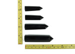 Dark obsidian obelisk crystal tower from GemstoneGO, showcasing a sleek black mineral with a polished finish.