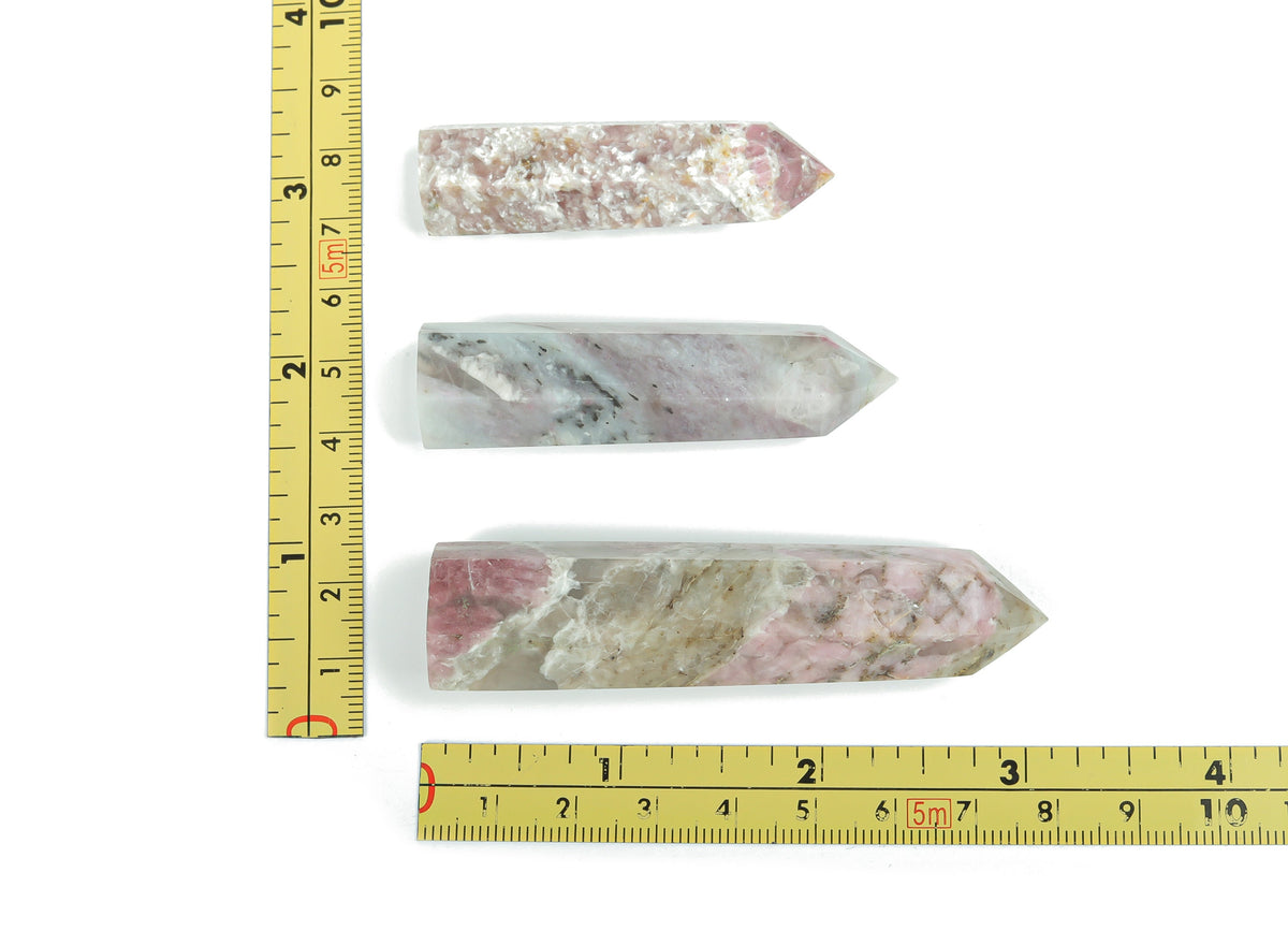 Plum Blossom Tourmaline obelisk tower crystal by GemstoneGO, showcasing pink and green tourmaline hues with a pointed obelisk shape.