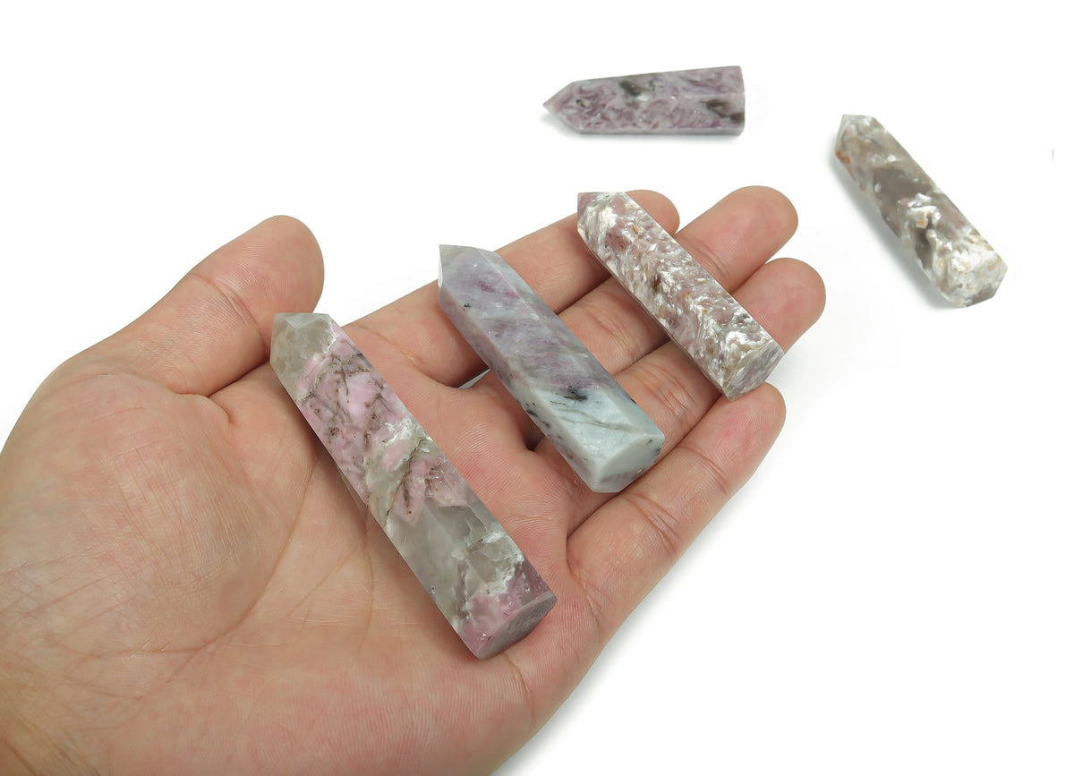 Plum blossom tourmaline obelisk tower crystal from GemstoneGO, featuring a tall, polished gemstone with pink and green hues.