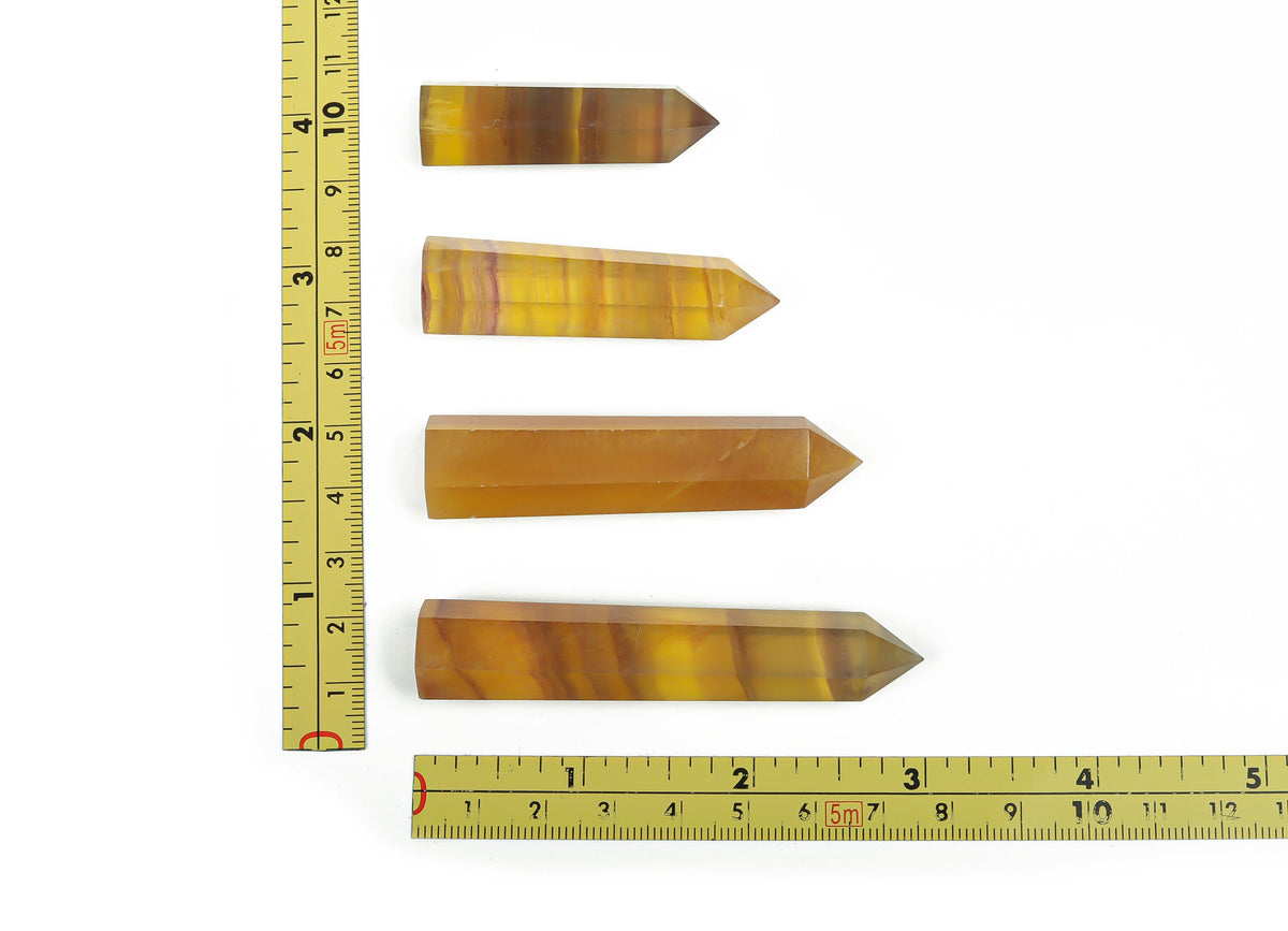 Yellow fluorite obelisk tower crystal by GemstoneGO, showcasing a vibrant yellow mineral with smooth polished surfaces and natural crystal details.