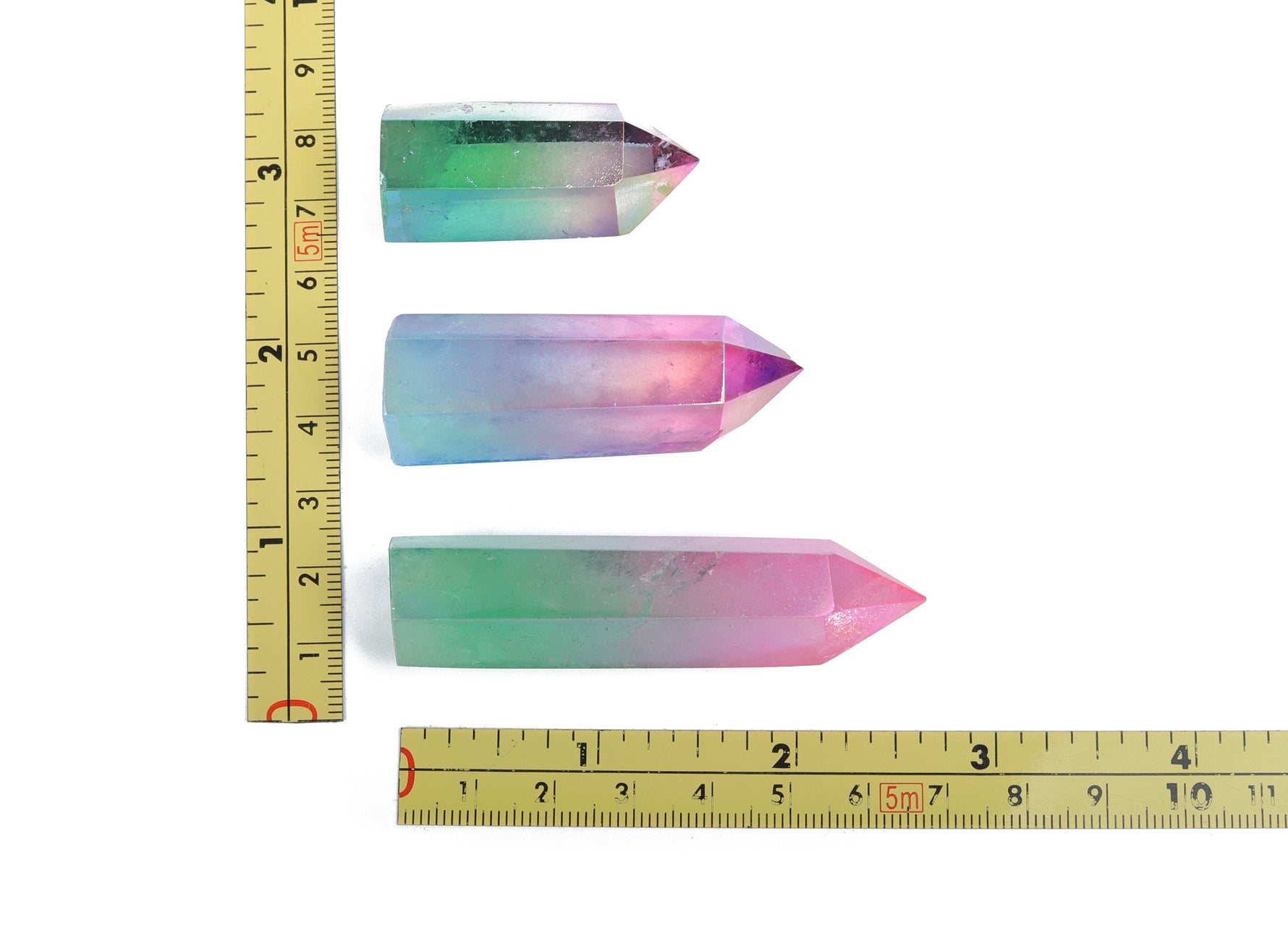 Rainbow Aura Quartz obelisk tower crystal from GemstoneGO, showcasing vibrant rainbow-colored quartz with a pointed obelisk shape.