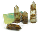 Yellow smelting quartz obelisk tower crystal from GemstoneGO, featuring a pointed yellow quartz crystal with natural stone details.