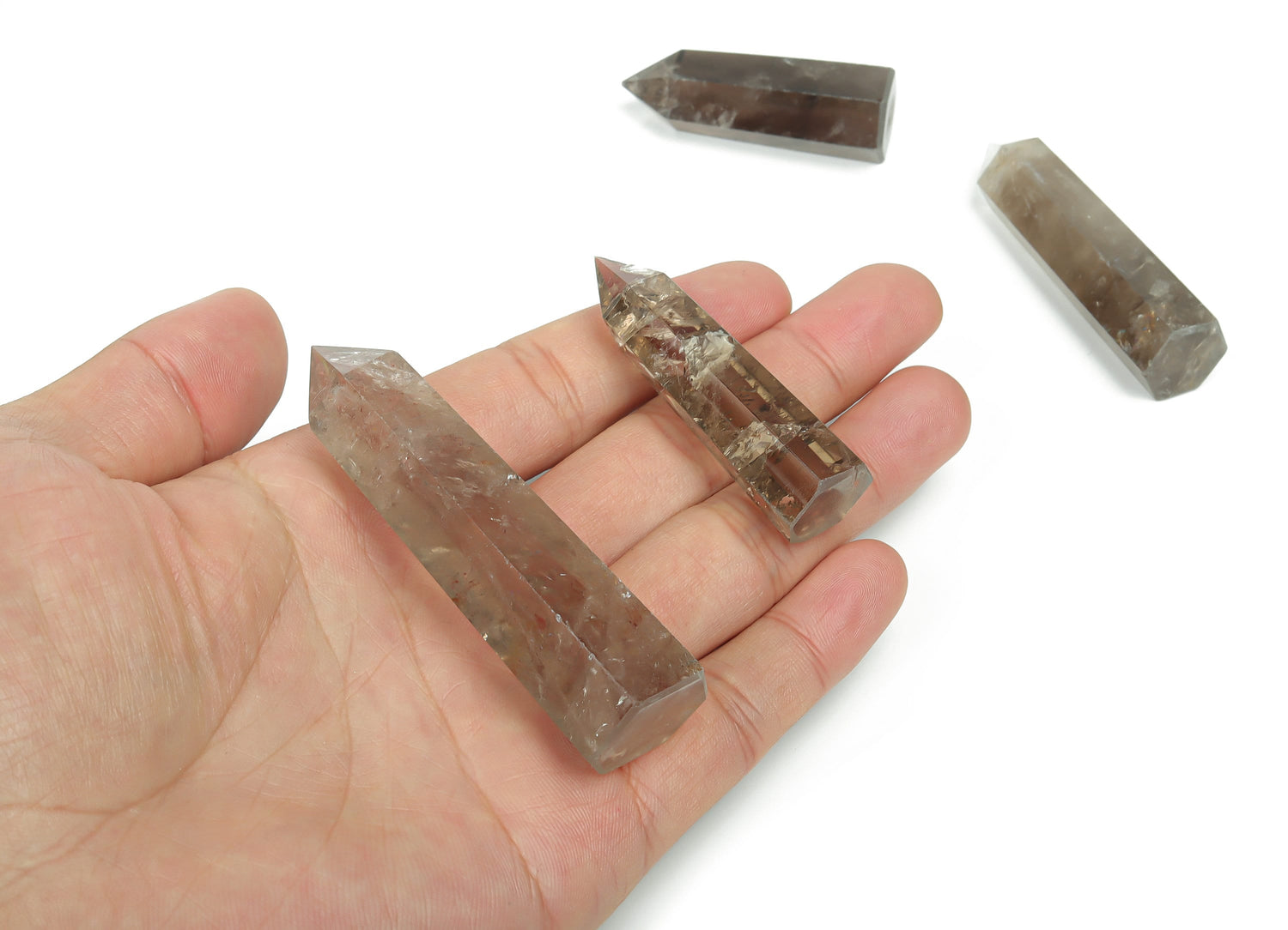 Smoky Quartz obelisk tower crystal from GemstoneGO, showcasing a polished, dark gray gemstone with natural crystal formations.