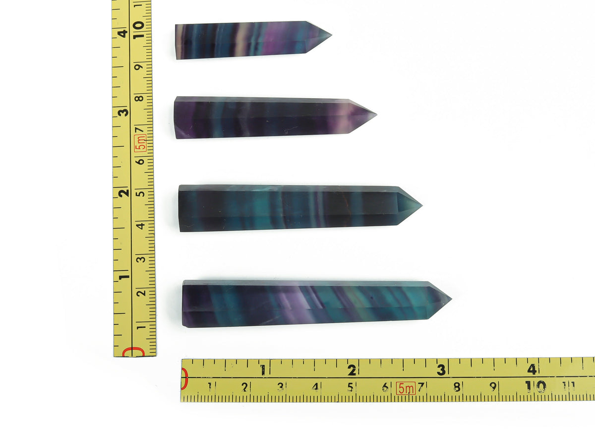 Rainbow fluorite obelisk tower crystal from GemstoneGO, showcasing vibrant rainbow colors and smooth polished surface.