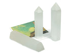 Selenite obelisk tower crystal by GemstoneGO, tall white mineral with smooth polished surface and natural crystal facets.