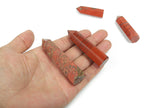 Red Jasper obelisk crystal tower from GemstoneGO, showcasing deep red stone with natural patterns and a pointed top.