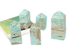 Blue Caribbean Calcite Druzy Obelisk Tower crystal from GemstoneGO featuring a polished blue and white mineral display