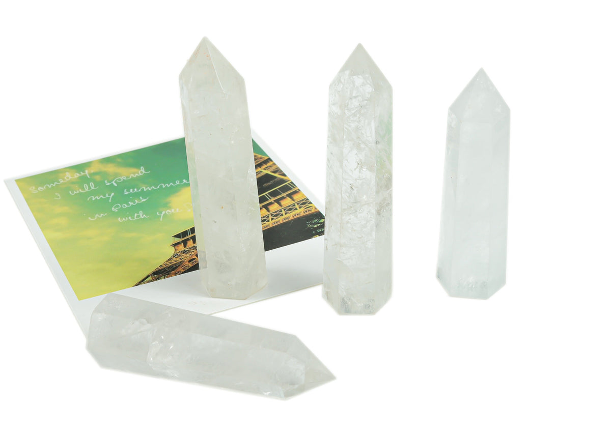 Clear quartz obelisk tower crystal from GemstoneGO, showcasing a tall, polished stone with natural clarity and smooth facets.