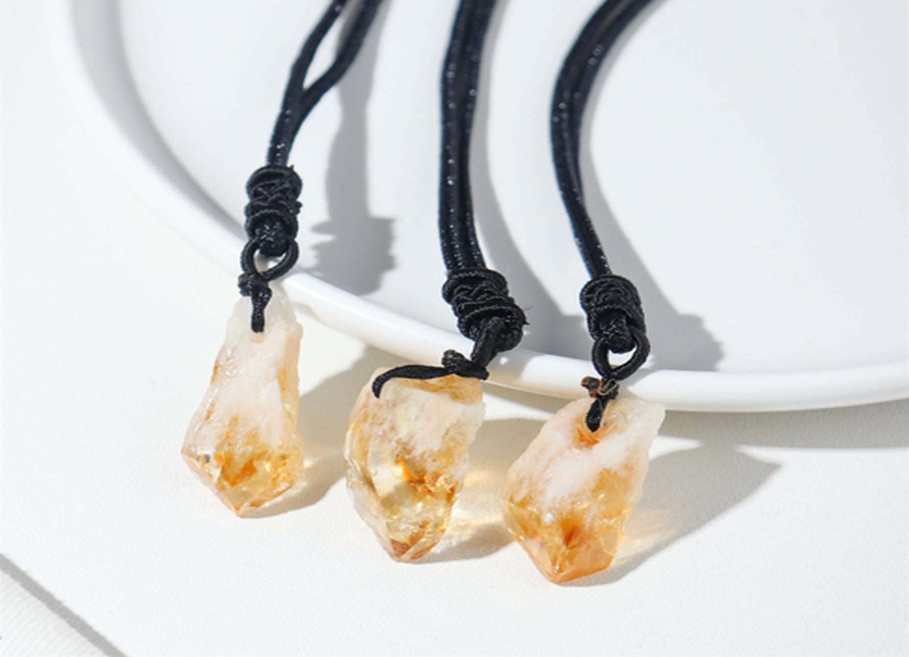 Citrine crystal necklace with cord, featuring a polished yellow gemstone pendant, styled for casual or gift-giving occasions.