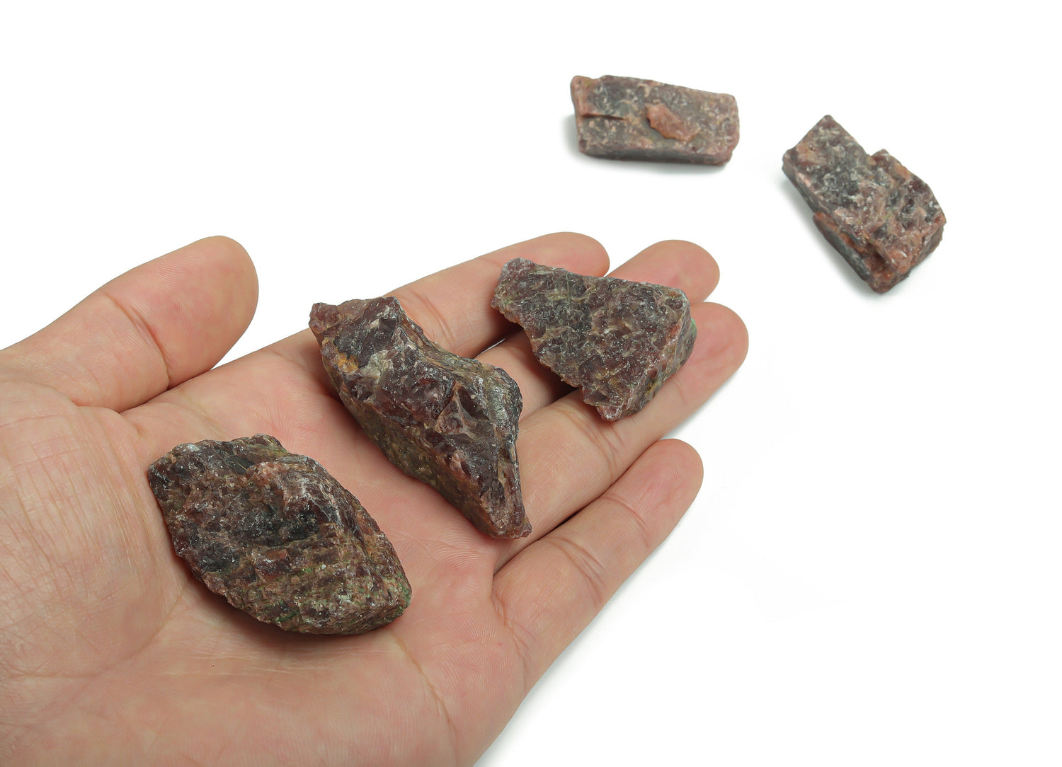 Raw garnet gemstone from GemstoneGO, showcasing a deep red, uncut mineral with natural facets and earthy texture.