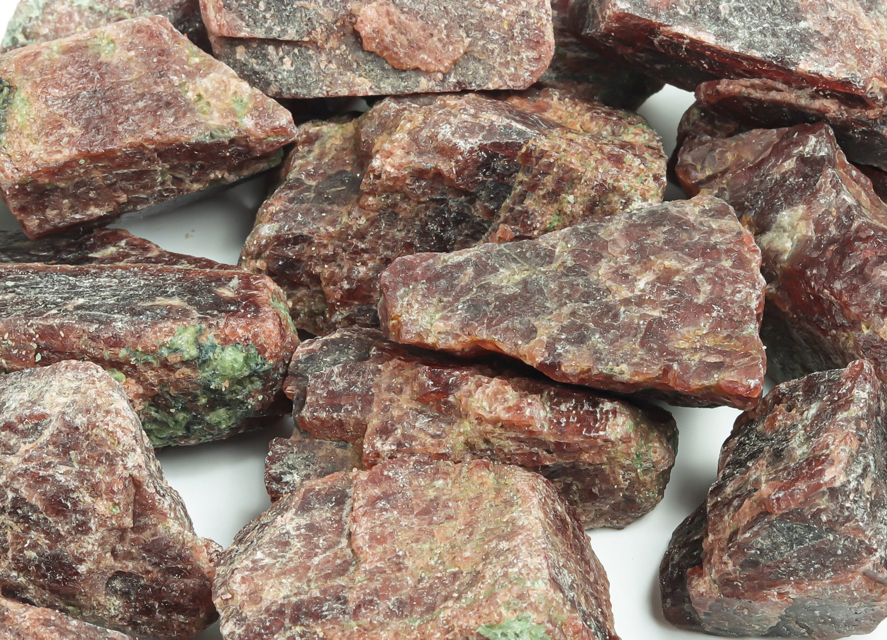 Raw garnet gemstone from GemstoneGO with deep red color and rough, uncut surface, showcasing natural mineral formation.