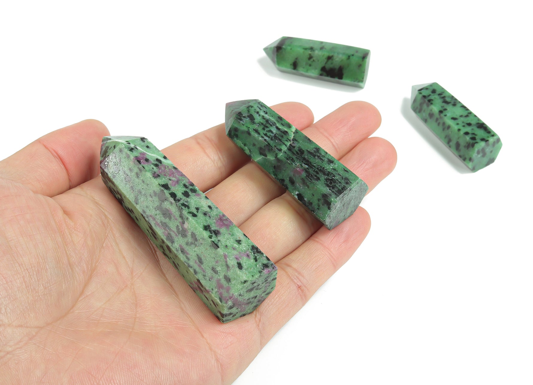 Ruby Zoisite obelisk tower crystal from GemstoneGO, showcasing a vibrant multicolored gemstone with a pointed tower shape.
