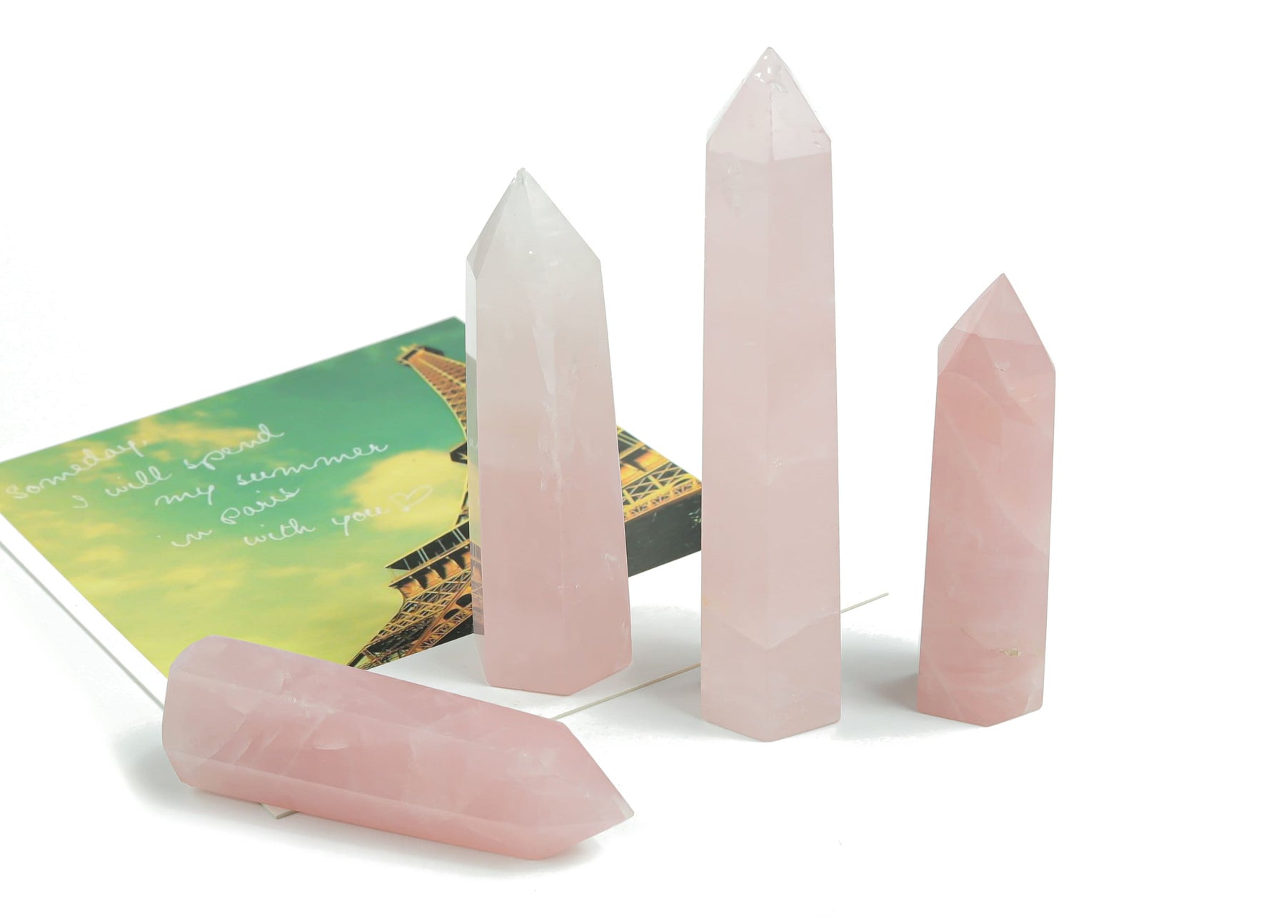 Rose Quartz obelisk tower crystal from GemstoneGO, showing a pink, polished gemstone with a pointed tip on a white background.