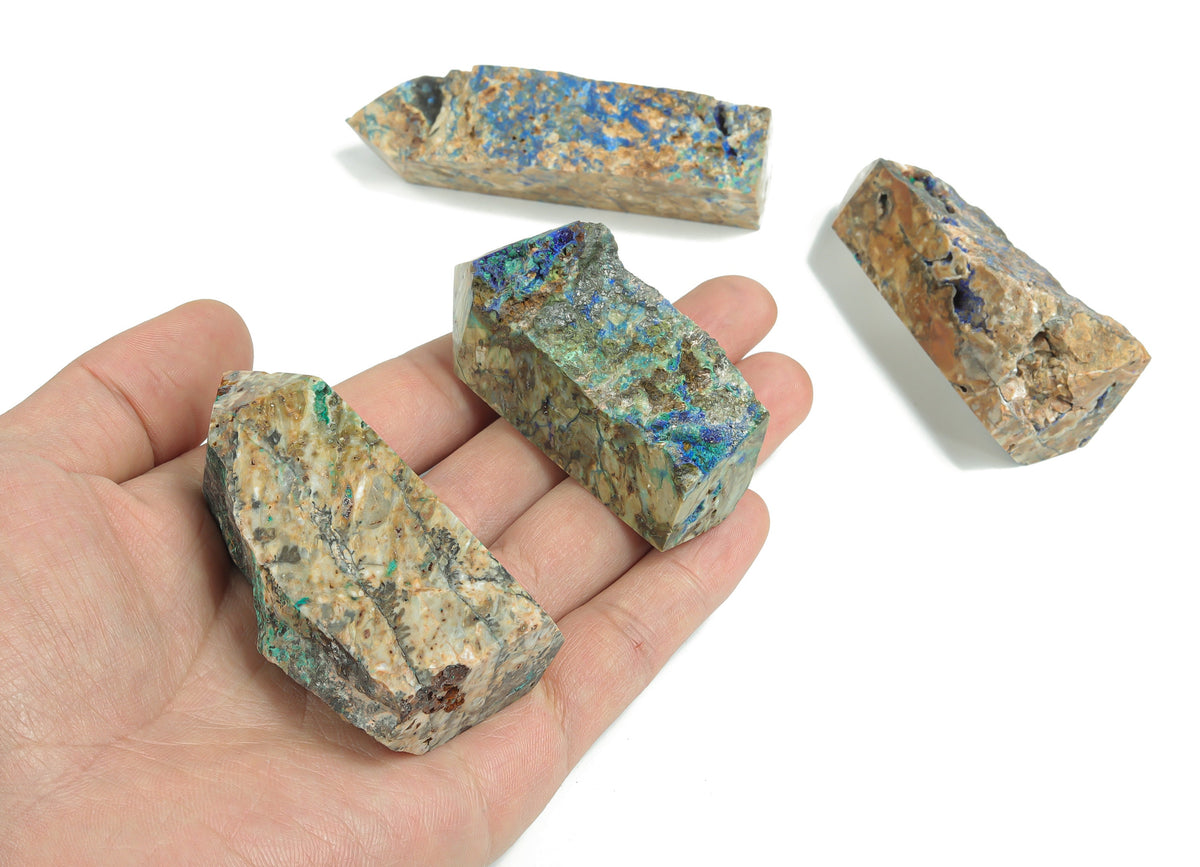 Azurite obelisk tower crystal from GemstoneGO, showcasing deep blue mineral formations with a polished pointed top.