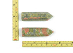 Unakite obelisk tower crystal from GemstoneGO, showing a polished green and pink gemstone obelisk with natural stone patterns.