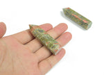 Unakite obelisk tower crystal from GemstoneGO, showcasing pink and green mineral patterns on a polished stone surface.