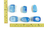 Blue Opalite tumbled stone from GemstoneGO, smooth polished gemstone with a vibrant blue and iridescent glow.