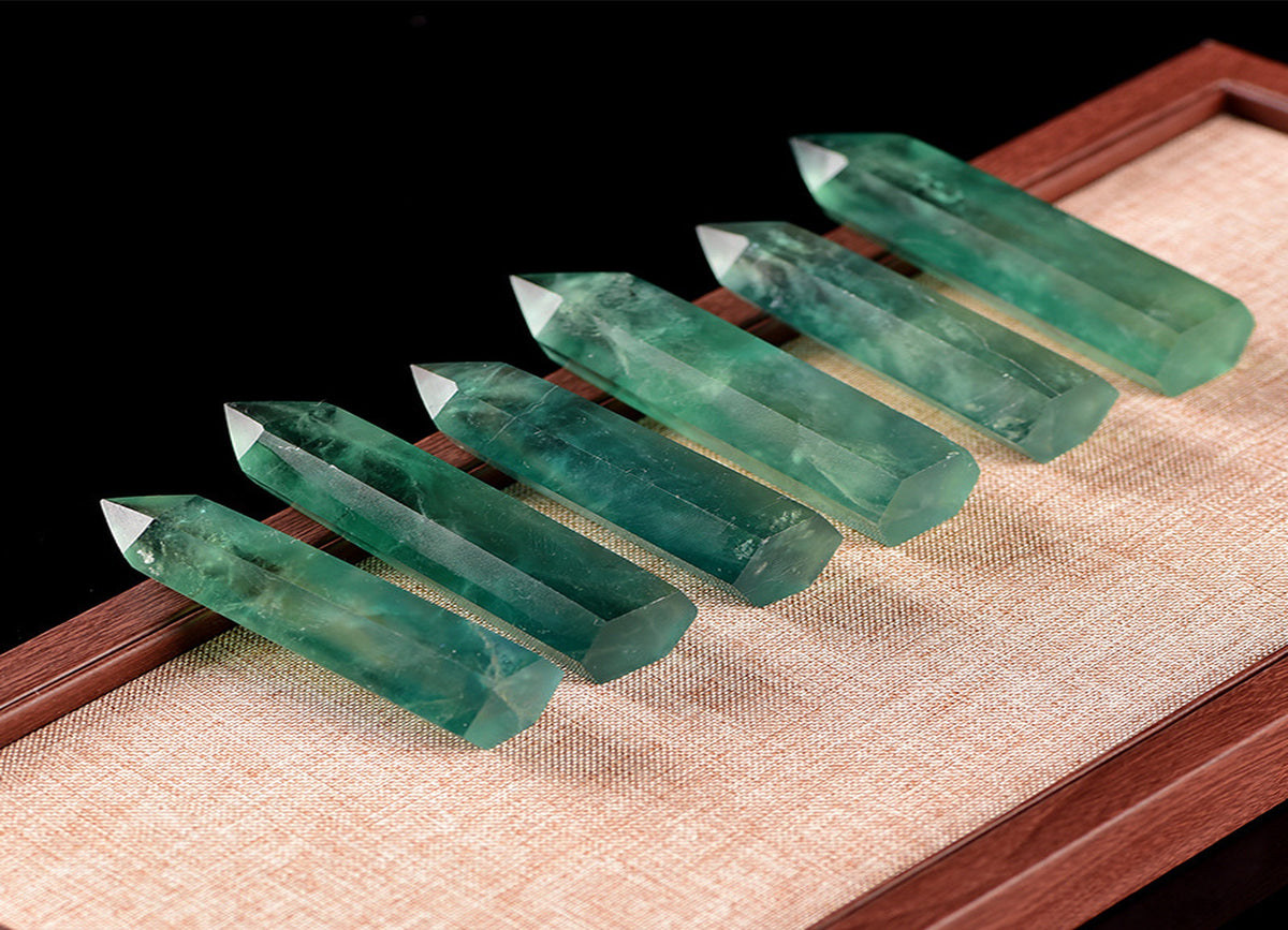 Green fluorite obelisk tower crystal from GemstoneGO, showcasing its vibrant green color and smooth polished surface.