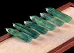 Green fluorite obelisk tower crystal from GemstoneGO, showcasing its vibrant green color and smooth polished surface.