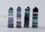 Rainbow fluorite obelisk tower crystal from GemstoneGO, showcasing vibrant rainbow colors and polished stone surface.