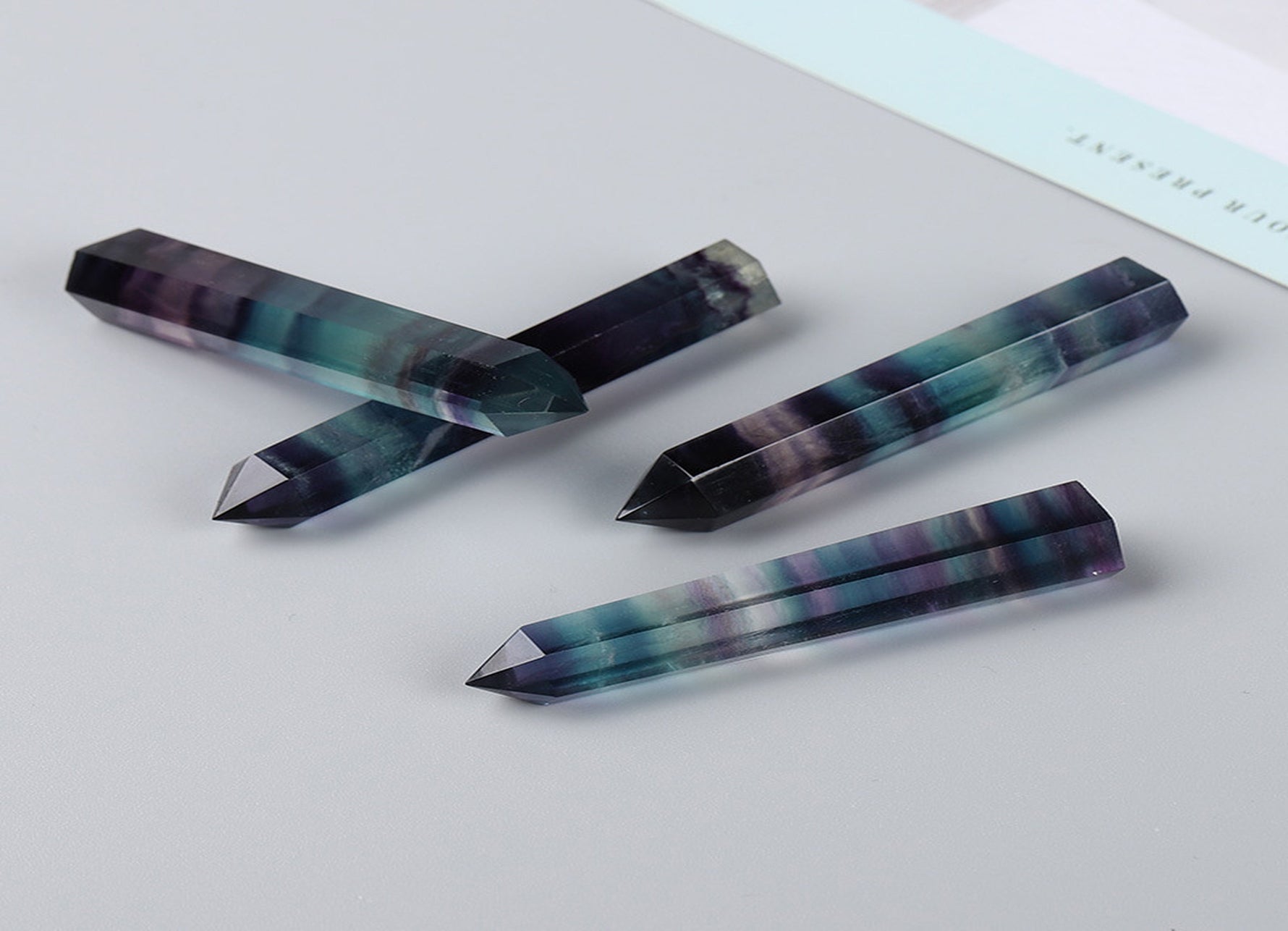 Rainbow fluorite obelisk tower crystal by GemstoneGO, showcasing vibrant rainbow colors and polished stone surface.